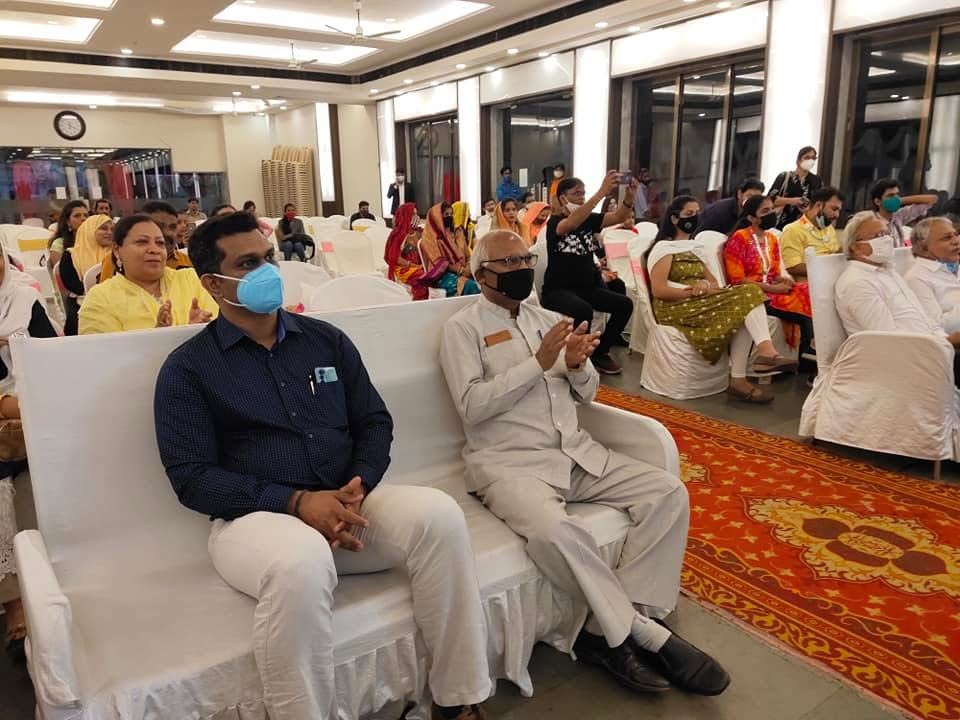 Seated guests applaud during the Corona Warrior Award ceremony, most of them wearing face masks.